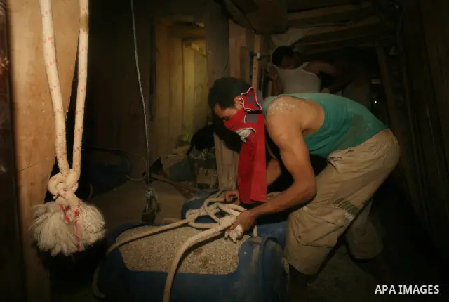 Palestinian men smuggle gravels into the Gaza Strip through a tunnel under the Egypt-Gaza border in Rafah on Oct. 16, 2011. Israel released a list of 477 Palestinian prisoners to be released next week as part of the deal...