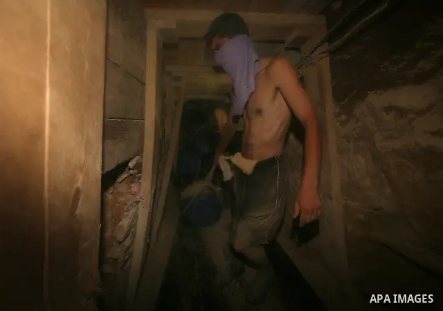 Palestinian men smuggle gravels into the Gaza Strip through a tunnel under the Egypt-Gaza border in Rafah on Oct. 16, 2011. Israel released a list of 477 Palestinian prisoners to be released next week as part of the deal...