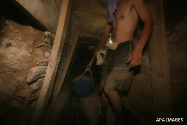 Palestinian men smuggle gravels into the Gaza Strip through a tunnel under the Egypt-Gaza border in Rafah on Oct. 16, 2011. Israel released a list of 477 Palestinian prisoners to be released next week as part of the deal...