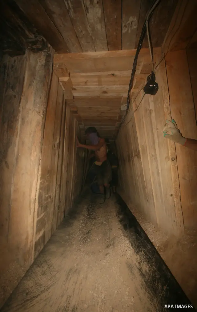 Palestinian men smuggle gravels into the Gaza Strip through a tunnel under the Egypt-Gaza border in Rafah on Oct. 16, 2011. Israel released a list of 477 Palestinian prisoners to be released next week as part of the deal...
