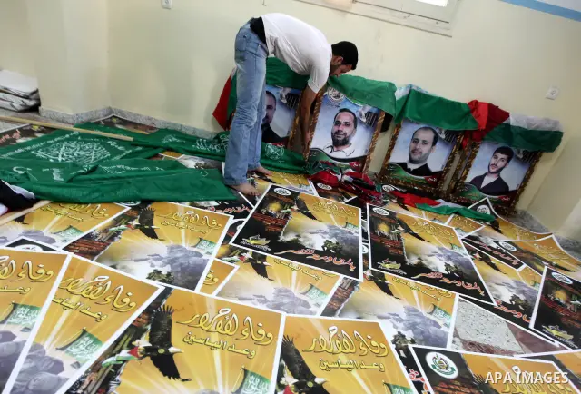 Palestinians print posters in preparation for a prisoner swap between Hamas and Israel in Gaza City, Sunday, Oct. 16, 2011. Relatives of Israelis killed in Palestinian attacks waged a charged debate Sunday over the plann...