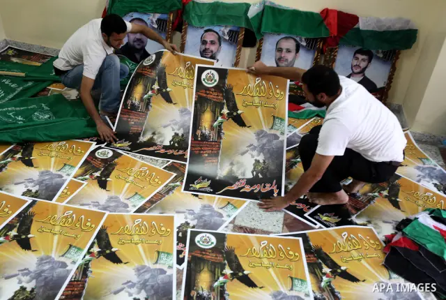 Palestinians print posters in preparation for a prisoner swap between Hamas and Israel in Gaza City, Sunday, Oct. 16, 2011. Relatives of Israelis killed in Palestinian attacks waged a charged debate Sunday over the plann...