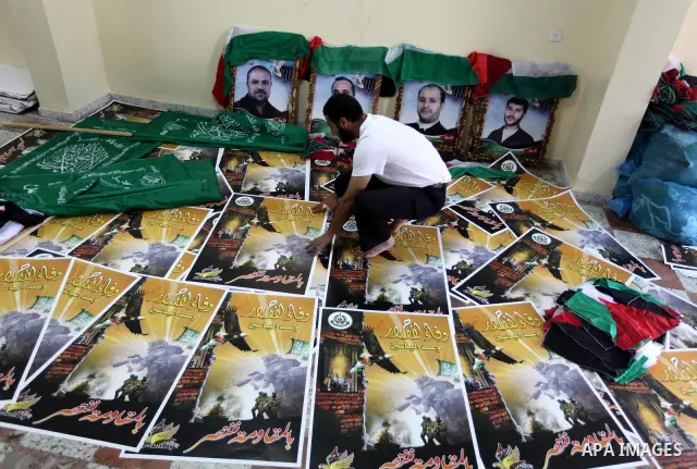 Palestinians print posters in preparation for a prisoner swap between Hamas and Israel in Gaza City, Sunday, Oct. 16, 2011. Relatives of Israelis killed in Palestinian attacks waged a charged debate Sunday over the plann...
