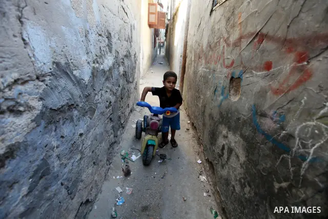 Palestinian children play at alley in Shati refugee camp in Gaza City, Sunday, Oct. 16, 2011. The relatives of Israelis killed in Palestinian attacks waged a charged debate Sunday over the planned release of militants th...