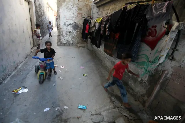 Palestinian children play at alley in Shati refugee camp in Gaza City, Sunday, Oct. 16, 2011. The relatives of Israelis killed in Palestinian attacks waged a charged debate Sunday over the planned release of militants th...