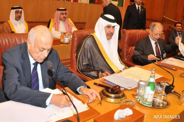 Arab League Secretary General Nabil Alarabi (L), Qatari Foreign Minister Hamad bin Jasim (C) and Arab League representative Ahmed Bin Hille (R) attend the Arab Foreign Ministers emergency meeting on Syria, at the Arab Le...