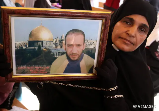 Relatives of Palestinian prisoners eat sweets as they celebrate the upcoming release of Palestinian inmates held in Israeli jails, on Oct. 17, 2011 at the Red Cross' offices in Gaza City. Under a prisoner swap deal signe...