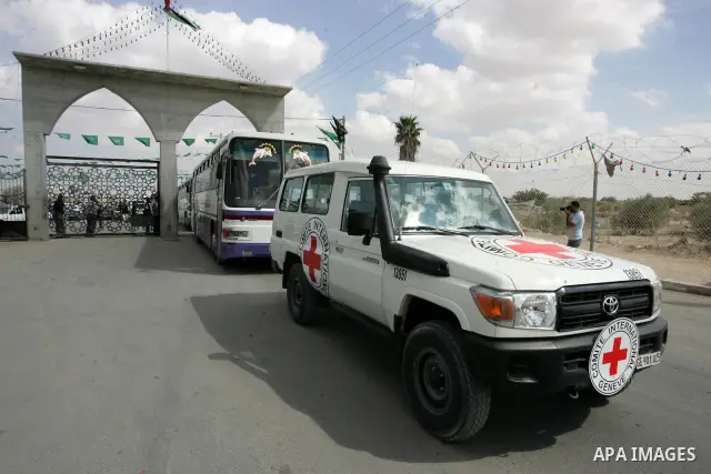 Red Cross vehicles and buses arrive from Egypt to the Rafah crossing in the southern Gaza Strip on Oct, 17. 2011 for the upcoming transfer of Palestinian prisoners from Israel to Gaza . Under a prisoner swap deal signed...