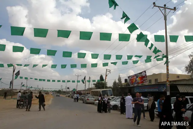 Palestinians gather at the Rafah border crossing in the southern Gaza Strip October 17, 2011, during preparations for the release of prisoners in a swap that is expected to take place on Tuesday. Hamas prepared a heroes'...