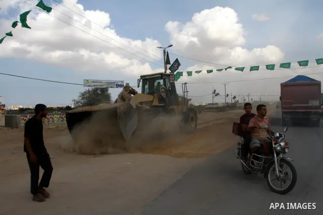 Palestinians gather at the Rafah border crossing in the southern Gaza Strip October 17, 2011, during preparations for the release of prisoners in a swap that is expected to take place on Tuesday. Hamas prepared a heroes'...