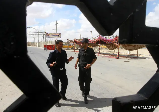 Palestinian Hamas policemen stand guard at the Rafah border crossing in the southern Gaza Strip October 17, 2011, during preparations for the release of prisoners in a swap that is expected to take place on Tuesday. Hama...