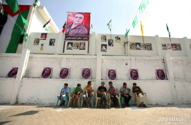 The family of Palestinian prisoner Raafat Aroki gather at a relative's house in the Gaza Strip on 17 October 2011 as they await his release as part of a deal to secure the exchange of Israeli captive soldier Gilad Shalit...