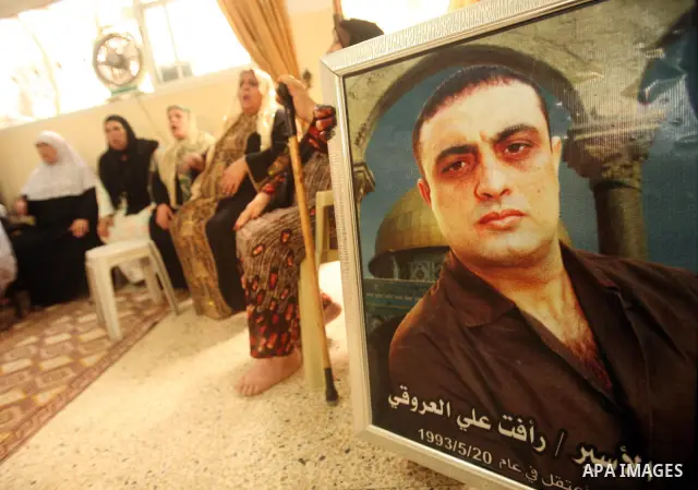 The family of Palestinian prisoner Raafat Aroki gather at a relative's house in the Gaza Strip on 17 October 2011 as they await his release as part of a deal to secure the exchange of Israeli captive soldier Gilad Shalit...