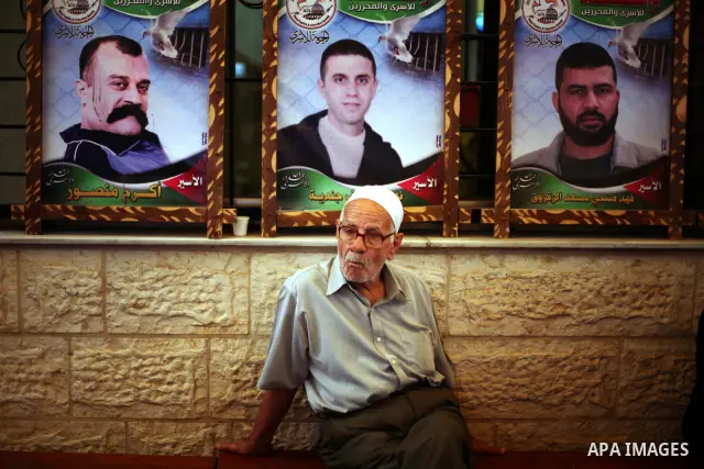 Palestinians gather during a protest at the Red Cross' offices in Gaza City to call for the release of Palestinian prisoners held in Israeli jails, on October 17, 2011. Under a prisoner swap deal signed with Israel, the...