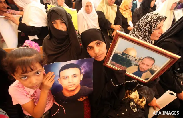 Palestinians gather during a protest at the Red Cross' offices in Gaza City to call for the release of Palestinian prisoners held in Israeli jails, on October 17, 2011. Under a prisoner swap deal signed with Israel, the...