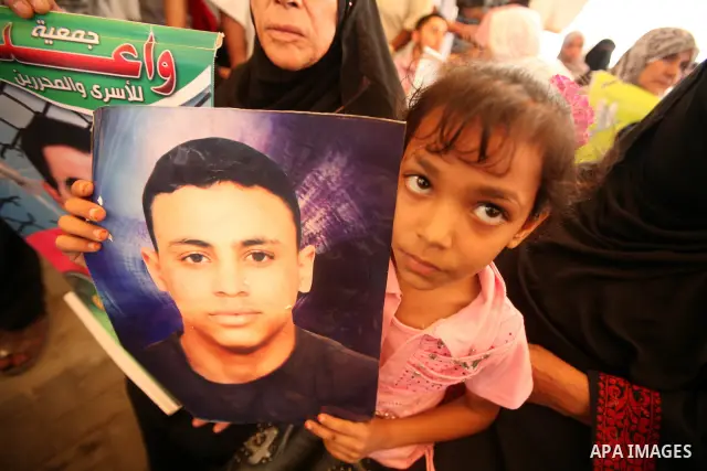 Palestinians gather during a protest at the Red Cross' offices in Gaza City to call for the release of Palestinian prisoners held in Israeli jails, on October 17, 2011. Under a prisoner swap deal signed with Israel, the...