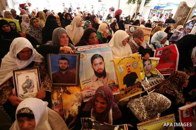 Palestinians gather during a protest at the Red Cross' offices in Gaza City to call for the release of Palestinian prisoners held in Israeli jails, on October 17, 2011. Under a prisoner swap deal signed with Israel, the...