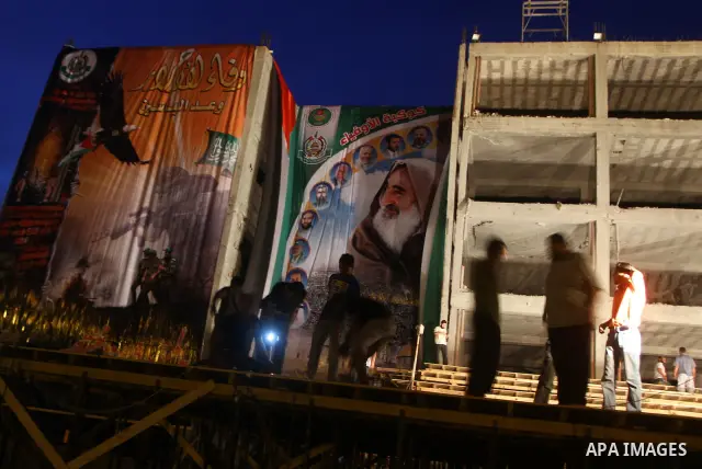 Palestinian men work on the stage that will be used to welcome prisoners released in the swap with Israel in Gaza City, Monday, Oct. 17, 2011. The elaborate machinery of a prisoner swap deal between two bitter enemies sw...