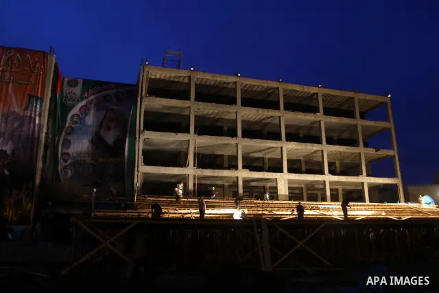 Palestinian men work on the stage that will be used to welcome prisoners released in the swap with Israel in Gaza City, Monday, Oct. 17, 2011. The elaborate machinery of a prisoner swap deal between two bitter enemies sw...