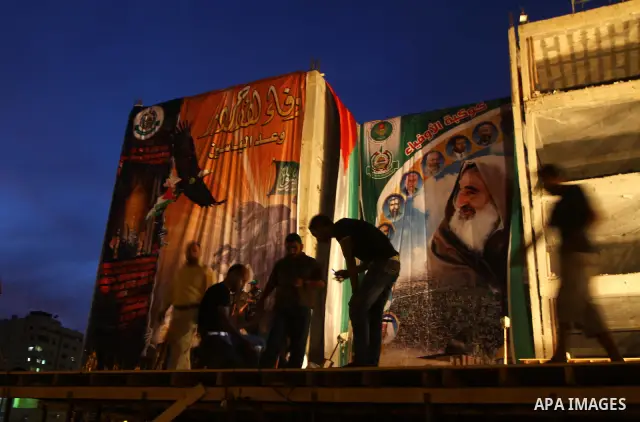 Palestinian men work on the stage that will be used to welcome prisoners released in the swap with Israel in Gaza City, Monday, Oct. 17, 2011. The elaborate machinery of a prisoner swap deal between two bitter enemies sw...