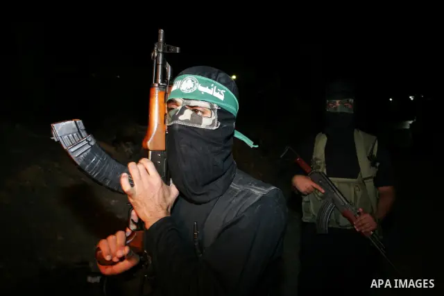 Palestinian Hamas militants stand guard on the main road in Khan Younis, southern Gaza Strip, Monday, Oct. 17, 2011. The exchange between Israel and Hamas in which 1,027 Palestinian prisoners will be released for capture...