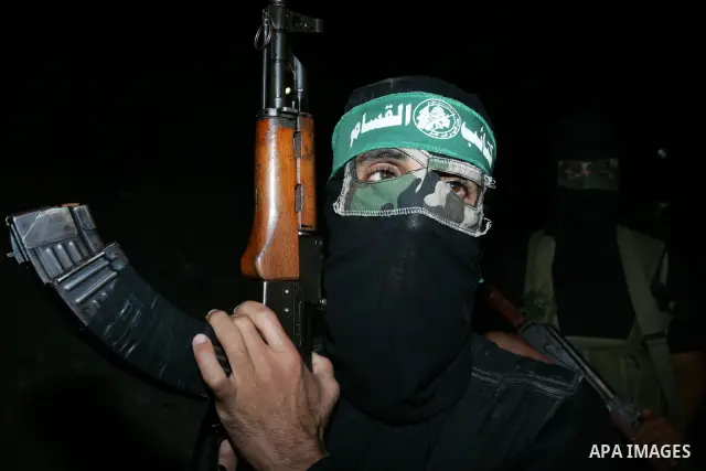Palestinian Hamas militants stand guard on the main road in Khan Younis, southern Gaza Strip, Monday, Oct. 17, 2011. The exchange between Israel and Hamas in which 1,027 Palestinian prisoners will be released for capture...