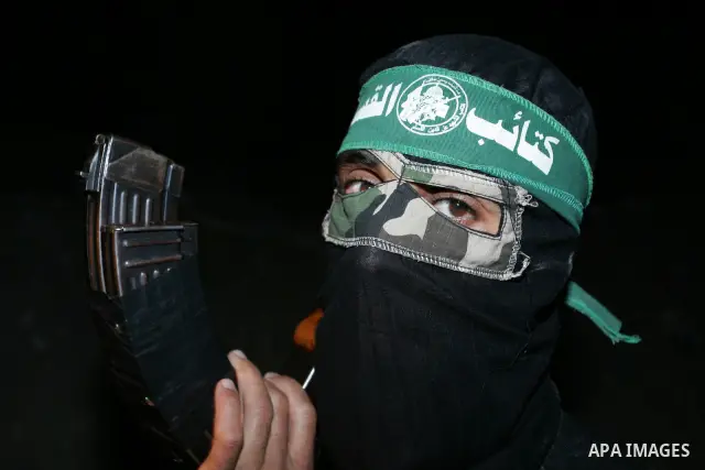 Palestinian Hamas militants stand guard on the main road in Khan Younis, southern Gaza Strip, Monday, Oct. 17, 2011. The exchange between Israel and Hamas in which 1,027 Palestinian prisoners will be released for capture...