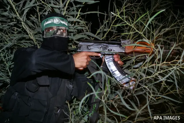 Palestinian Hamas militants stand guard on the main road in Khan Younis, southern Gaza Strip, Monday, Oct. 17, 2011. The exchange between Israel and Hamas in which 1,027 Palestinian prisoners will be released for capture...
