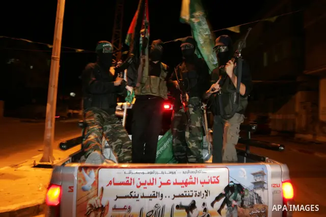 Palestinian Hamas militants stand guard on the main road in Khan Younis, southern Gaza Strip, Monday, Oct. 17, 2011. The exchange between Israel and Hamas in which 1,027 Palestinian prisoners will be released for capture...