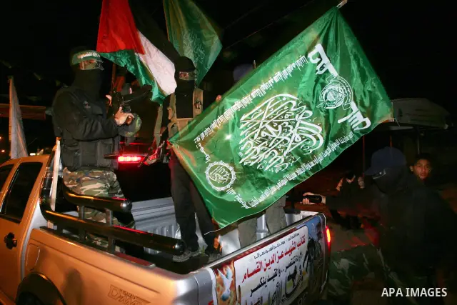 Palestinian Hamas militants stand guard on the main road in Khan Younis, southern Gaza Strip, Monday, Oct. 17, 2011. The exchange between Israel and Hamas in which 1,027 Palestinian prisoners will be released for capture...