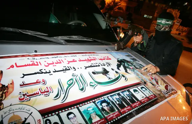 Palestinian Hamas militants stand guard on the main road in Khan Younis, southern Gaza Strip, Monday, Oct. 17, 2011. The exchange between Israel and Hamas in which 1,027 Palestinian prisoners will be released for capture...