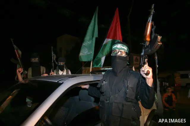 Palestinian Hamas militants stand guard on the main road in Khan Younis, southern Gaza Strip, Monday, Oct. 17, 2011. The exchange between Israel and Hamas in which 1,027 Palestinian prisoners will be released for capture...