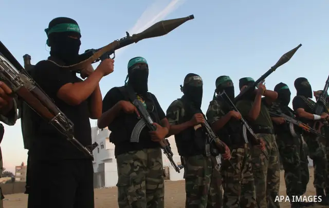Armed Palestinian Hamas militants keep patrol near the Rafah crossing with Egypt in the southern Gaza Strip on October 18, 2011 as an Israeli-Palestinian prisoner swap deal gets under way. Buses carrying 477 Palestinian...
