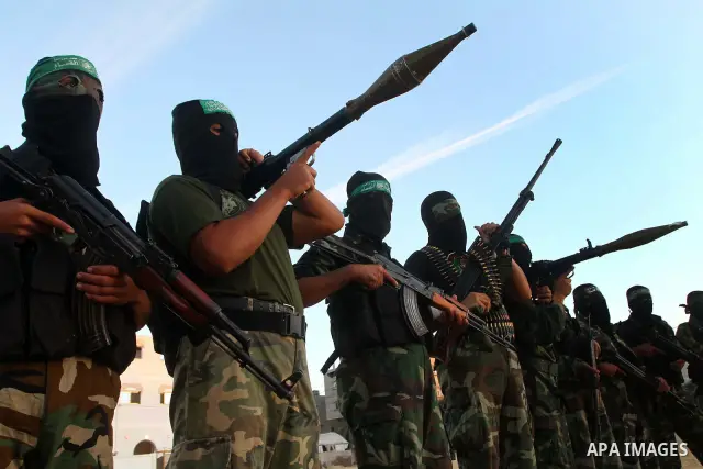 Armed Palestinian Hamas militants keep patrol near the Rafah crossing with Egypt in the southern Gaza Strip on October 18, 2011 as an Israeli-Palestinian prisoner swap deal gets under way. Buses carrying 477 Palestinian...