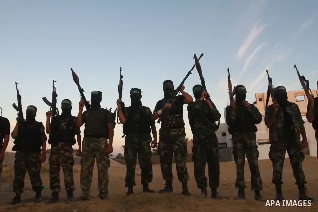 Armed Palestinian Hamas militants keep patrol near the Rafah crossing with Egypt in the southern Gaza Strip on October 18, 2011 as an Israeli-Palestinian prisoner swap deal gets under way. Buses carrying 477 Palestinian...