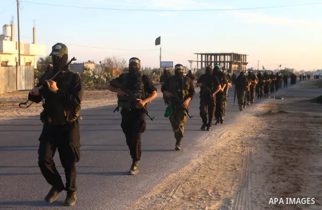 Armed Palestinian Hamas militants keep patrol near the Rafah crossing with Egypt in the southern Gaza Strip on October 18, 2011 as an Israeli-Palestinian prisoner swap deal gets under way. Buses carrying 477 Palestinian...