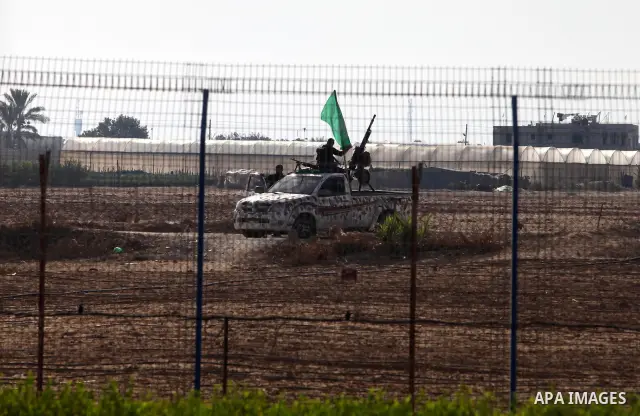 Armed Palestinian Hamas militants keep patrol near the Rafah crossing with Egypt in the southern Gaza Strip on October 18, 2011 as an Israeli-Palestinian prisoner swap deal gets under way. Buses carrying 477 Palestinian...