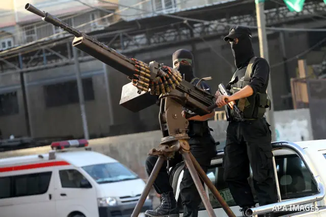 Armed Palestinian Hamas militants stand guard at a street in Gaza city on October 18, 2011 as an Israeli-Palestinian prisoner swap deal gets under way. Buses carrying 477 Palestinian prisoners were headed for Gaza and th...