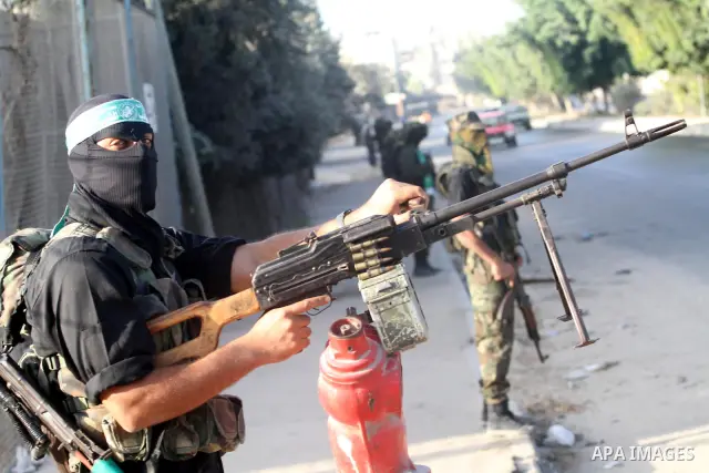 Armed Palestinian Hamas militants stand guard at a street in Gaza city on October 18, 2011 as an Israeli-Palestinian prisoner swap deal gets under way. Buses carrying 477 Palestinian prisoners were headed for Gaza and th...