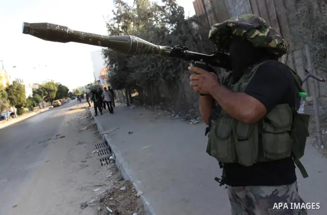 Armed Palestinian Hamas militants stand guard at a street in Gaza city on October 18, 2011 as an Israeli-Palestinian prisoner swap deal gets under way. Buses carrying 477 Palestinian prisoners were headed for Gaza and th...