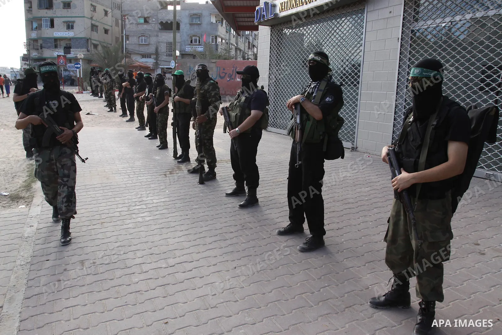 Armed Palestinian Hamas militants stand guard at a street in Gaza city on October 18, 2011 as an Israeli-Palestinian prisoner swap deal gets under way. Buses carrying 477 Palestinian prisoners were headed for Gaza and th...