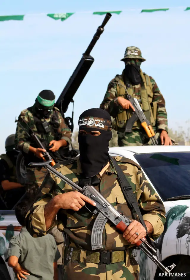 Armed Palestinian Hamas militants keep watch near the Rafah crossing with Egypt in the southern Gaza Strip on October 18, 2011 as an Israeli-Palestinian prisoner swap deal gets under way. Buses carrying 477 Palestinian p...
