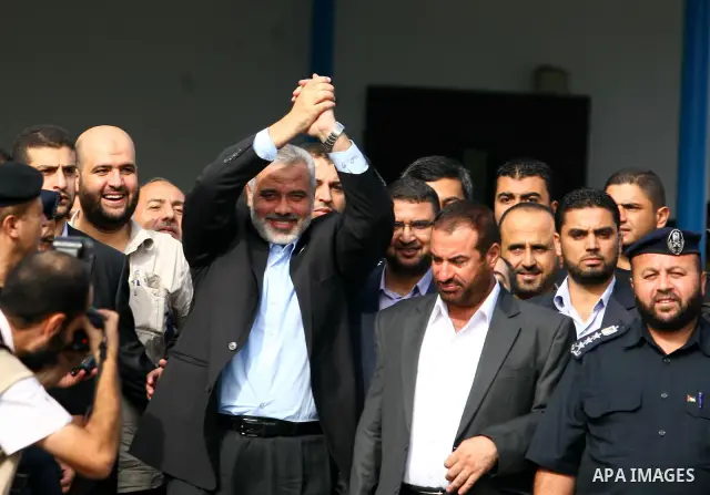 Palestinian Prime Minister in Gaza Strip, Ismail Haniya waves to his supporters during his arrival to Rafah crossing with Egypt in the southern Gaza Strip on October 18, 2011 as an Israeli-Palestinian prisoner swap deal...