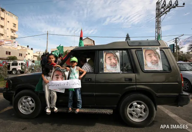 Palestinians participate in the celebrations in Gaza City on October 18, 2011 as an Israeli-Palestinian prisoner swap deal gets under way. Captive Israeli soldier Gilad Shalit was today freed from five years of Hamas cap...