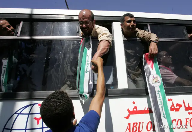 Palestinian prisoners cross to the southern Gaza Strip from the Egyptian side of the Rafah border on Oct. 18, 2011 upon their release from Israeli prisons under a landmark deal to free abducted Israeli soldier Gilad Shal...