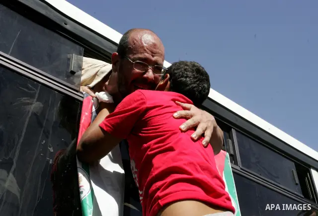 Palestinian prisoners cross to the southern Gaza Strip from the Egyptian side of the Rafah border on Oct. 18, 2011 upon their release from Israeli prisons under a landmark deal to free abducted Israeli soldier Gilad Shal...
