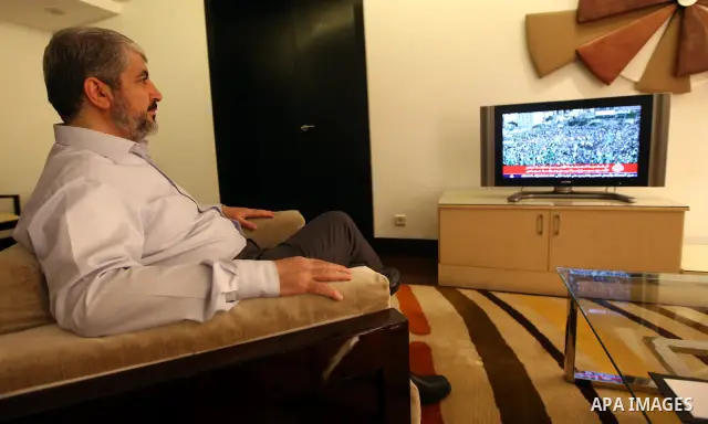Palestinian Hamas leader Khaled Meshaal watches TV in at his residential headquarters in Cairo, Egypt Oct. 18,2011. Gaza's Hamas Islamist rulers released captured Israeli soldier Gilad Shalit on Tuesday in return for hun...