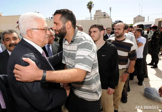Palestinian president Mahmud Abbas welcomes hundreds of prisoners released from Israeli jails on Oct. 18, 2011 at the Palestinian Authority headquarters in the West Bank city of Ramallah. Hundreds of people gathered in R...