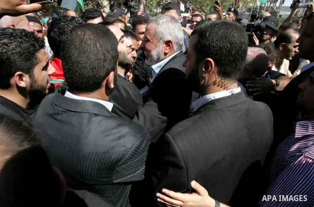 Palestinian Prime Minister in Gaza Strip, Ismail Haniyeh greets a released Palestinian prisoner at the Rafah border crossing in southern Gaza Strip, Tuesday, Oct. 18, 2011. The Hamas militant group released an Israeli so...