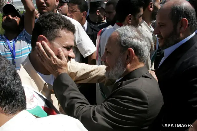 Palestinian Hamas leader, Mahmoud al-Zahar greets a released Palestinian prisoner at the Rafah border crossing in southern Gaza Strip, Tuesday, Oct. 18, 2011. The Hamas militant group released an Israeli soldier Tuesday...